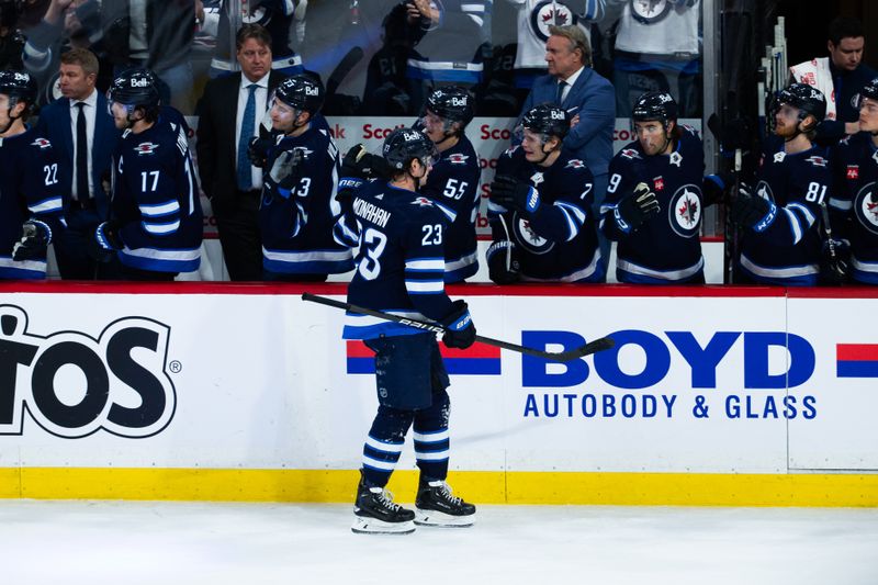 Feb 20, 2024; Winnipeg, Manitoba, CAN; Winnipeg Jets forward Sean Monahan (23) is congratulated by his team mates on his goal against the Minnesota Wild during third period at Canada Life Centre. Mandatory Credit: Terrence Lee-USA TODAY Sports