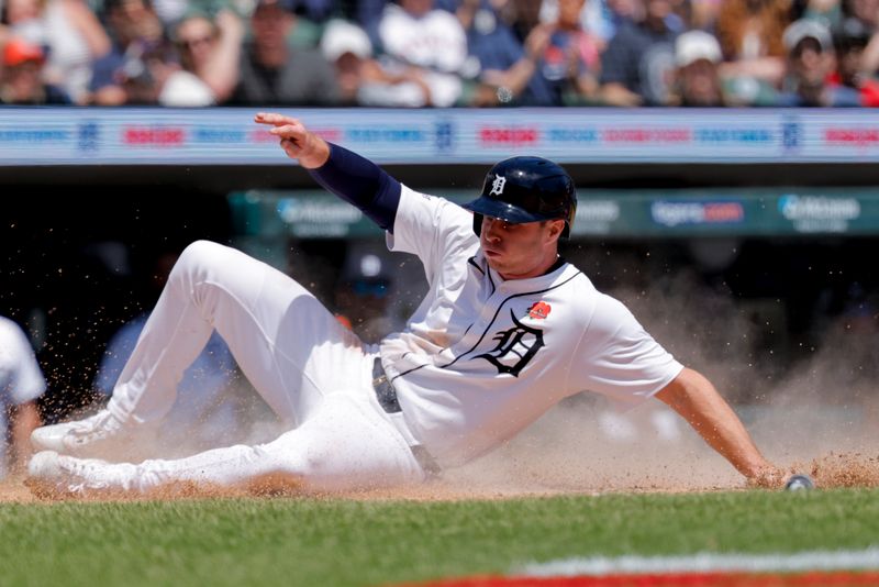 May 26, 2025; Detroit, Michigan, USA;  Detroit Tigers second base Colt Keith (33) slides in safe at home against the San Francisco Giants in the fourth inning at Comerica Park. Mandatory Credit: Rick Osentoski-Imagn Images