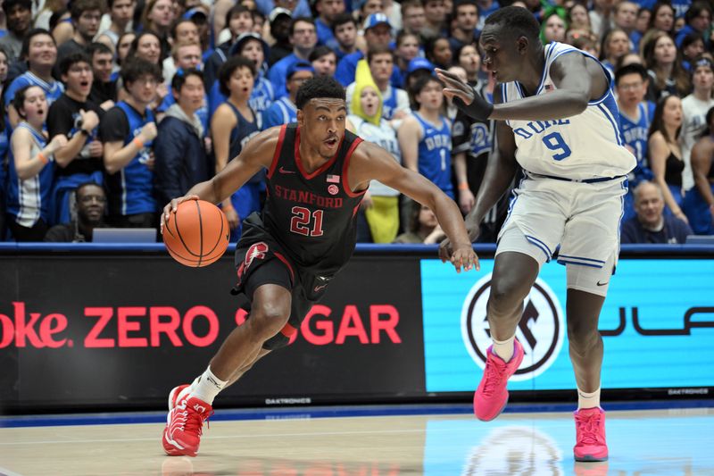 Feb 15, 2025; Durham, North Carolina, USA;  Stanford Cardinal guard Jaylen Blakes (21) drives the ball under pressure from Duke Blue Devils center Khaman Maluach (9) during the first half at Cameron Indoor Stadium. Mandatory Credit: Zachary Taft-Imagn Images