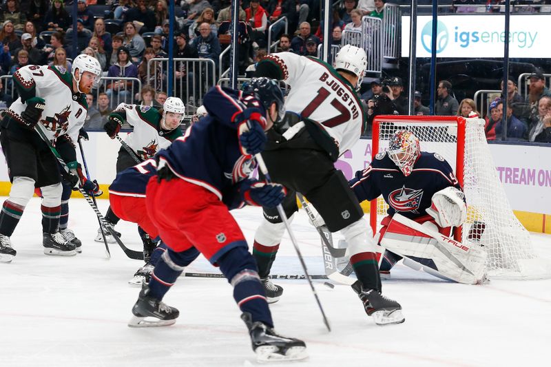 Nov 16, 2023; Columbus, Ohio, USA; Columbus Blue Jackets goalie Elvis Merzlikins (90) makes a stick save on the shot from Arizona Coyotes center Nick Bjugstad (17) during the first period at Nationwide Arena. Mandatory Credit: Russell LaBounty-USA TODAY Sports