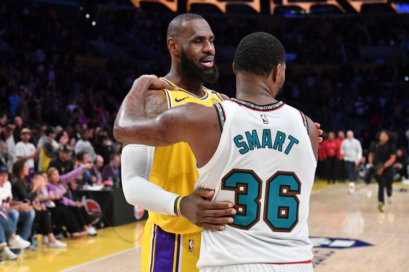 LOS ANGELES, CA - OCTOBER 22:  LeBron James #23 of the Los Angeles Lakers speaks with Marcus Smart #36 of the Memphis Grizzlies after the game on October 22, 2024 at Crypto.com Arena in Los Angeles, California. NOTE TO USER: User expressly acknowledges and agrees that, by downloading and/or using this Photograph, user is consenting to the terms and conditions of the Getty Images License Agreement. Mandatory Copyright Notice: Copyright 2024 NBAE (Photo by Juan Ocampo/NBAE via Getty Images)