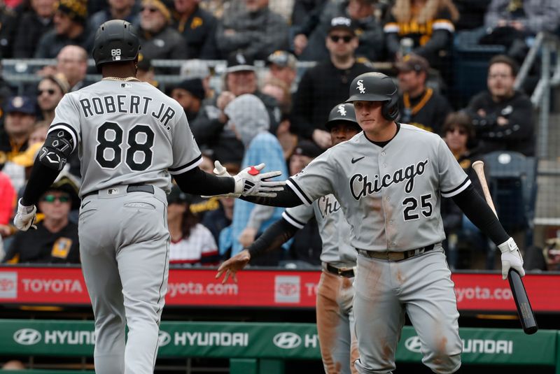 Apr 7, 2023; Pittsburgh, Pennsylvania, USA;  Chicago White Sox first baseman Andrew Vaughn (25) greets center fielder Luis Robert Jr. (88) crossing home plate on a two run home run against the Pittsburgh Pirates during the third inning at PNC Park. Mandatory Credit: Charles LeClaire-USA TODAY Sports