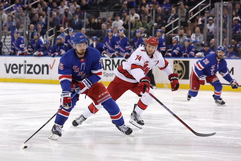 May 13, 2024; New York, New York, USA; New York Rangers center Jack Roslovic (96) looks to shoot the puck against Carolina Hurricanes defenseman Jaccob Slavin (74) during the second period of game five of the second round of the 2024 Stanley Cup Playoffs at Madison Square Garden. Mandatory Credit: Brad Penner-USA TODAY Sports