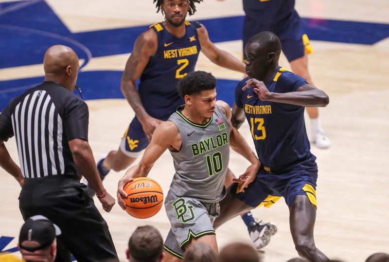 Feb 17, 2024; Morgantown, West Virginia, USA; Baylor Bears guard RayJ Dennis (10) dribbles against West Virginia Mountaineers forward Akok Akok (13) during the second half at WVU Coliseum. Mandatory Credit: Ben Queen-USA TODAY Sports