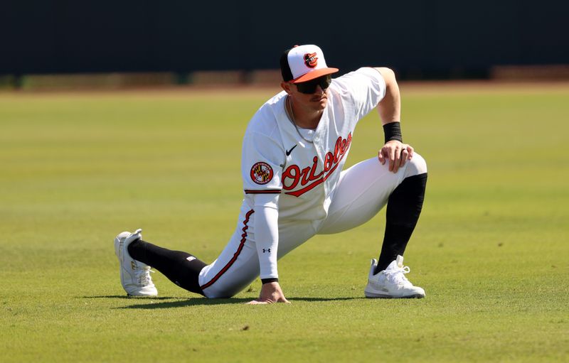 Feb 24, 2024; Sarasota, Florida, USA;Baltimore Orioles left fielder Austin Hays (21) stretches before the game against the Boston Red Sox at Ed Smith Stadium. Mandatory Credit: Kim Klement Neitzel-USA TODAY Sports