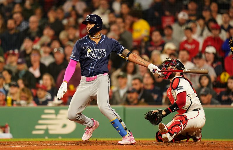 May 13, 2024; Boston, Massachusetts, USA; Tampa Bay Rays center fielder Jose Siri (22) hits a sacrifice fly ball to left field to drive in a run against the Boston Red Sox in the forth inning at Fenway Park. Mandatory Credit: David Butler II-USA TODAY Sports