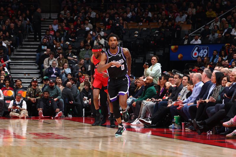 TORONTO, CANADA - MARCH 20: Malik Monk #0 of the Sacramento Kings celebrates during the game against the Toronto Raptors on March 20, 2024 at the Scotiabank Arena in Toronto, Ontario, Canada.  NOTE TO USER: User expressly acknowledges and agrees that, by downloading and or using this Photograph, user is consenting to the terms and conditions of the Getty Images License Agreement.  Mandatory Copyright Notice: Copyright 2024 NBAE (Photo by Vaughn Ridley/NBAE via Getty Images)