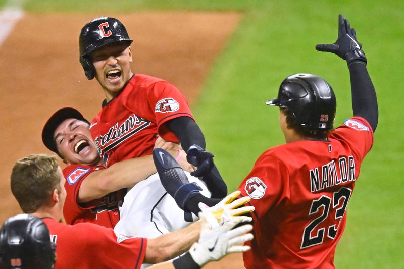 Sep 2, 2023; Cleveland, Ohio, USA; Cleveland Guardians left fielder Steven Kwan (38) is lifted in the air by right fielder Will Brennan (17) after hitting a game-winning RBI sacrifice fly against the Tampa Bay Rays in the eleventh inning at Progressive Field. Mandatory Credit: David Richard-USA TODAY Sports