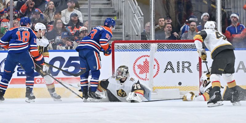 Dec 21, 2025; Edmonton, Alberta, CAN; Edmonton Oilers center Ryan Nugent-Hopkins (93) watches the puck go past Vegas Golden Knights goalie Carter Hart (79) during the second period at Rogers Place. Mandatory Credit: Walter Tychnowicz-Imagn Images