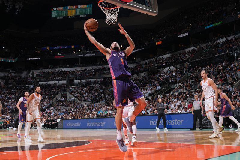 SAN ANTONIO, TX - MARCH 25: Devin Booker #1 of the Phoenix Suns drives to the basket during the game against the San Antonio Spurs on March 25, 2024 at the AT&T Center in San Antonio, Texas. NOTE TO USER: User expressly acknowledges and agrees that, by downloading and or using this photograph, user is consenting to the terms and conditions of the Getty Images License Agreement. Mandatory Copyright Notice: Copyright 2024 NBAE (Photos by Jesse D. Garrabrant/NBAE via Getty Images)