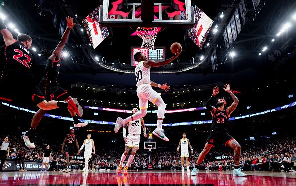 TORONTO, ON - DECEMBER 23: Ochai Agbaji #30 of the Utah Jazz goes to the basket against the Utah Jazz during the first half of their basketball game at the Scotiabank Arena on December 23, 2023 in Toronto, Ontario, Canada. NOTE TO USER: User expressly acknowledges and agrees that, by downloading and/or using this Photograph, user is consenting to the terms and conditions of the Getty Images License Agreement. (Photo by Mark Blinch/Getty Images)