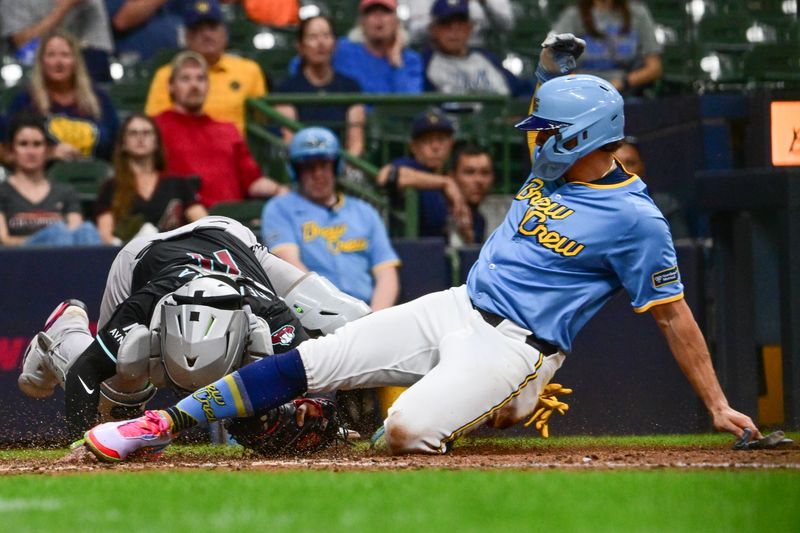 Sep 22, 2024; Milwaukee, Wisconsin, USA; Arizona Diamondbacks catcher Jose Herrera (11) tags out Milwaukee Brewers shortstop Willy Adames (27) trying to score in the seventh inning at American Family Field. Mandatory Credit: Benny Sieu-Imagn Images