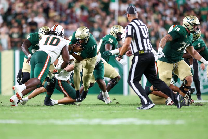 Sep 21, 2024; Tampa, Florida, USA; South Florida Bulls quarterback Byrum Brown (17) runs with the ball against the Miami Hurricanes in the third quarter  at Raymond James Stadium. Mandatory Credit: Nathan Ray Seebeck-Imagn Images