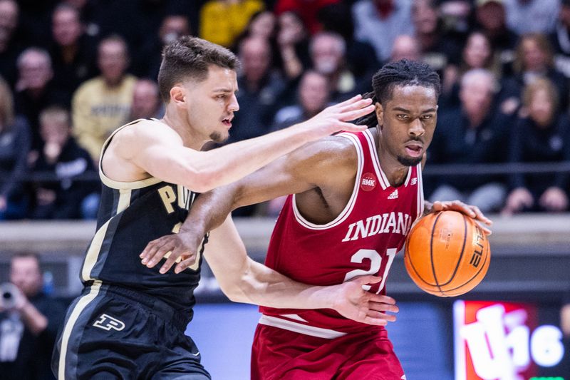 Feb 10, 2024; West Lafayette, Indiana, USA; Indiana Hoosiers forward Mackenzie Mgbako (21) dribbles the ball while Purdue Boilermakers guard Ethan Morton (25) defends in the first half at Mackey Arena. Mandatory Credit: Trevor Ruszkowski-USA TODAY Sports