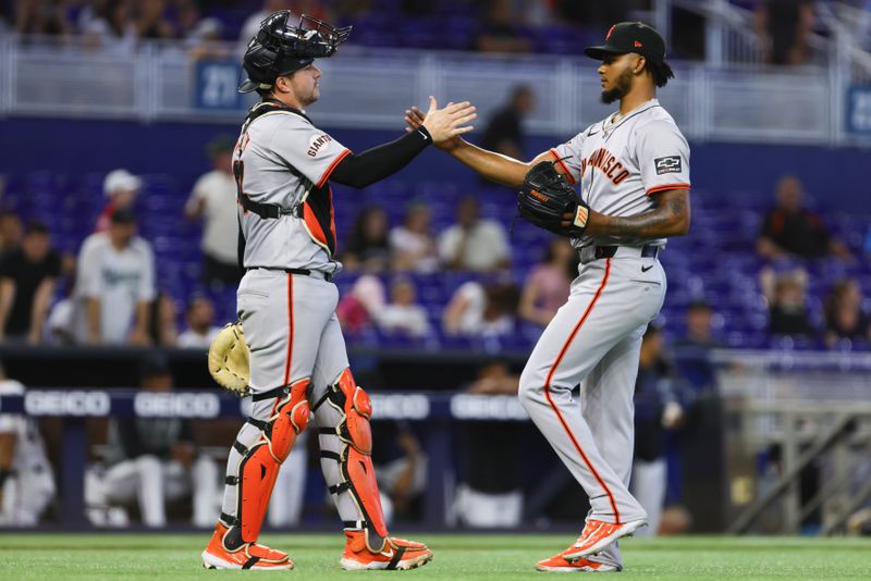 Apr 17, 2024; Miami, Florida, USA; San Francisco Giants relief pitcher Camilo Doval (75) celebrates with catcher Patrick Bailey (14) after the game against the Miami Marlins at loanDepot Park. Mandatory Credit: Sam Navarro-USA TODAY Sports