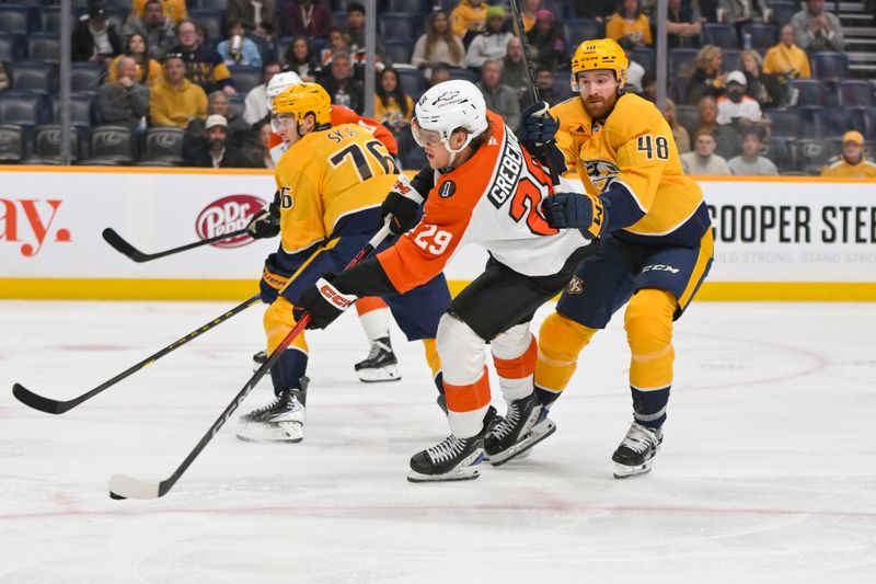 Nov 6, 2025; Nashville, Tennessee, USA;  Philadelphia Flyers right wing Nikita Grebenkin (29) takes a shot on goal as Nashville Predators defenseman Nick Perbix (48) checks him during the second period at Bridgestone Arena. Mandatory Credit: Steve Roberts-Imagn Images