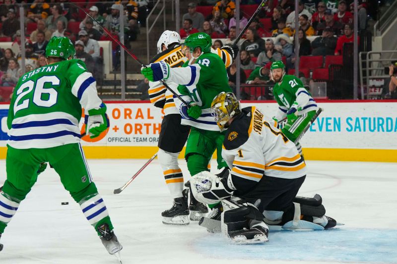 Mar 26, 2023; Raleigh, North Carolina, USA;  Boston Bruins goaltender Jeremy Swayman (1) defenseman Charlie McAvoy (73) and Carolina Hurricanes center Jack Drury (18) watch the shot during the first period at PNC Arena. Mandatory Credit: James Guillory-USA TODAY Sports