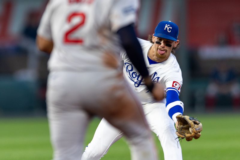 Aug 6, 2024; Kansas City, Missouri, USA; Kansas City Royals shortstop Bobby Witt Jr. (7) reaches for a throw to second base around Boston Red Sox first base Dominic Smith (2) during the fourth inning at Kauffman Stadium. Mandatory Credit: William Purnell-USA TODAY Sports