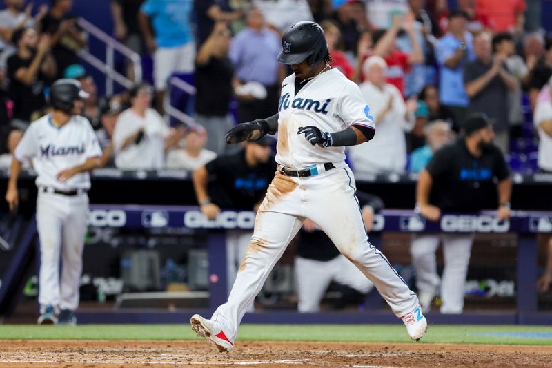 Jul 30, 2023; Miami, Florida, USA; Miami Marlins third baseman Jean Segura (9) scores after a two-run double by center fielder Garrett Hampson (not pictured) during the fifth inning at loanDepot Park. Mandatory Credit: Sam Navarro-USA TODAY Sports