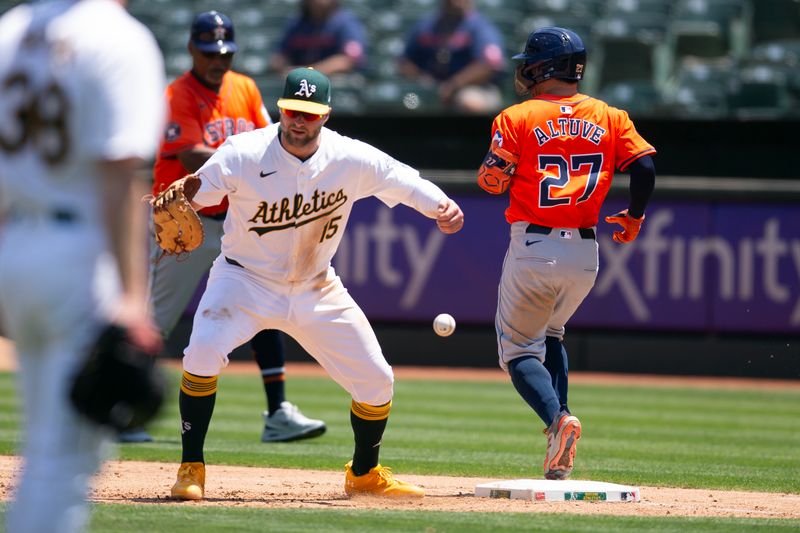 Jul 24, 2024; Oakland, California, USA; Houston Astros second baseman Jose Altuve (27) reaches base safely on a bad throw to Oakland Athletics first baseman Seth Brown (15) during the fifth inning at Oakland-Alameda County Coliseum. Mandatory Credit: D. Ross Cameron-USA TODAY Sports