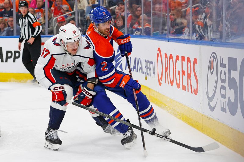 Mar 13, 2024; Edmonton, Alberta, CAN; Washington Capitals forward Beck Malenstyn (47) and Edmonton Oilers defensemen Evan Bouchard (2) Battle along the boards for a loose puck during the second period at Rogers Place. Mandatory Credit: Perry Nelson-USA TODAY Sports