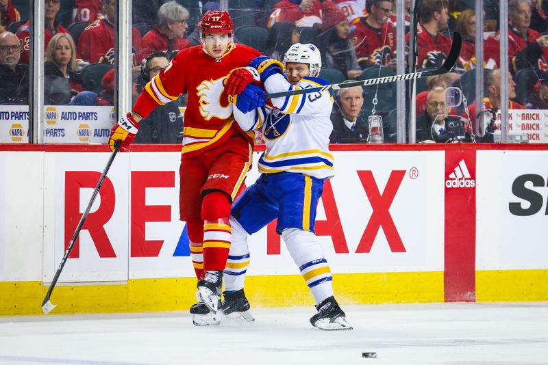 Mar 24, 2024; Calgary, Alberta, CAN; Calgary Flames center Yegor Sharangovich (17) and Buffalo Sabres left wing Jeff Skinner (53) battles for the puck during the first period at Scotiabank Saddledome. Mandatory Credit: Sergei Belski-USA TODAY Sports