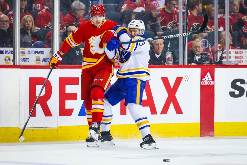 Mar 24, 2024; Calgary, Alberta, CAN; Calgary Flames center Yegor Sharangovich (17) and Buffalo Sabres left wing Jeff Skinner (53) battles for the puck during the first period at Scotiabank Saddledome. Mandatory Credit: Sergei Belski-USA TODAY Sports