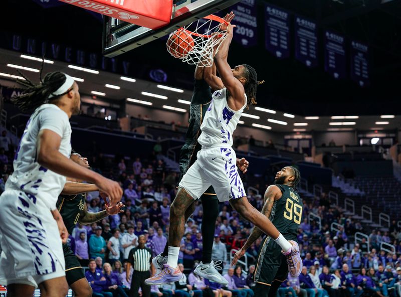 Jan 14, 2026; Manhattan, Kansas, USA; Kansas State Wildcats guard Nate Johnson (34) dunks the ball against UCF Knights forward Devan Cambridge (35) during the second half at Bramlage Coliseum. Mandatory Credit: Jay Biggerstaff-Imagn Images