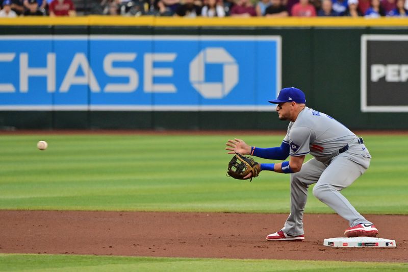 May 1, 2024; Phoenix, Arizona, USA;  Los Angeles Dodgers shortstop Miguel Rojas (11) catches a ball in the first inning against the Arizona Diamondbacks at Chase Field. Mandatory Credit: Matt Kartozian-USA TODAY Sports