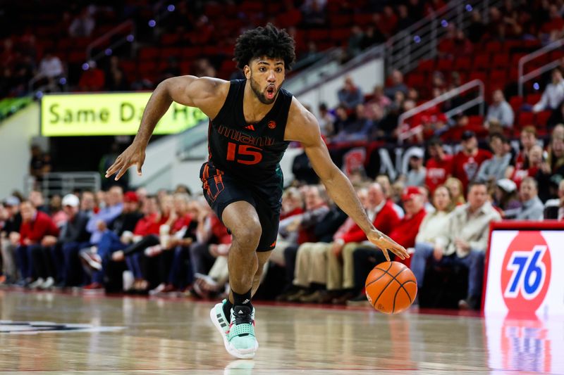 Jan 30, 2024; Raleigh, North Carolina, USA; Miami (Fl) Hurricanes forward Norchad Omier (15) dribbles with the ball during the second half against North Carolina State Wolfpack at PNC Arena. Mandatory Credit: Jaylynn Nash-USA TODAY Sports