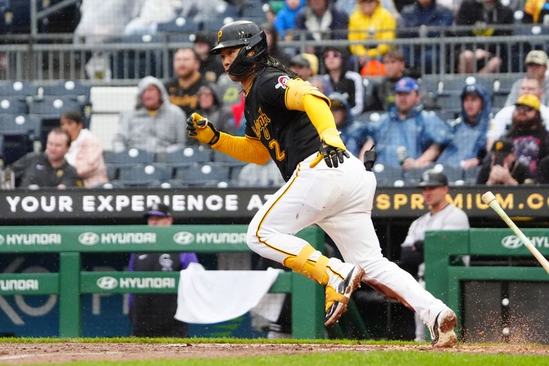 May 4, 2024; Pittsburgh, Pennsylvania, USA; Pittsburgh Pirates first baseman Connor Joe (2) runs out a single against the Colorado Rockies during the ninth inning at PNC Park. Mandatory Credit: Gregory Fisher-USA TODAY Sports