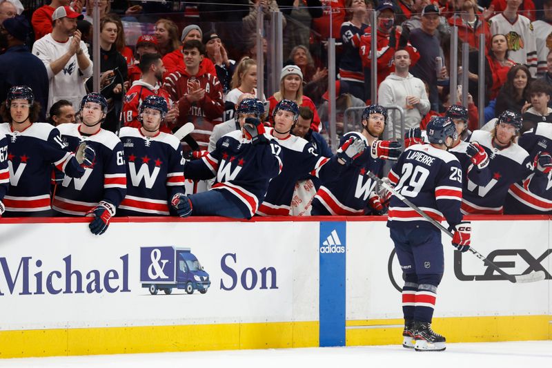 Mar 9, 2024; Washington, District of Columbia, USA; Washington Capitals center Hendrix Lapierre (29) celebrates with teammates after scoring a goal against the Chicago Blackhawks in the first period at Capital One Arena. Mandatory Credit: Geoff Burke-USA TODAY Sports