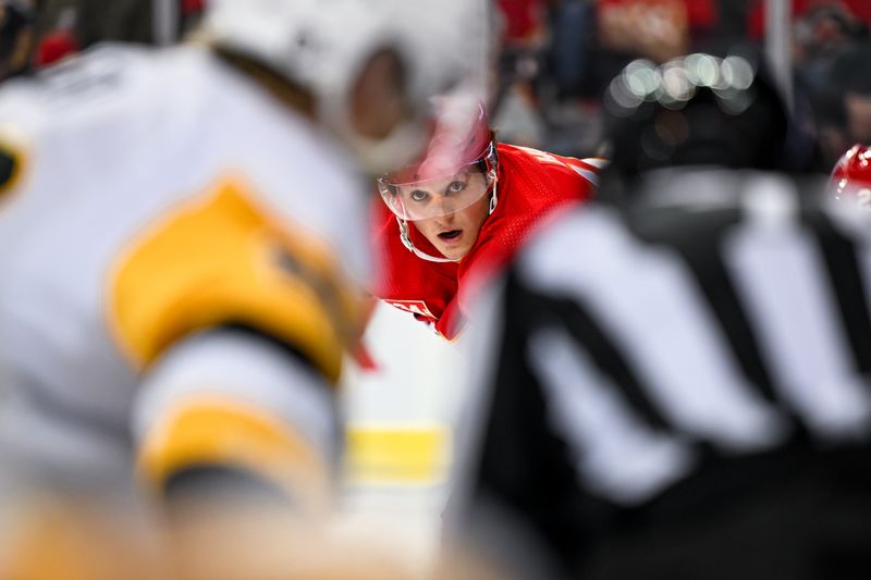 Mar 2, 2024; Calgary, Alberta, CAN; Calgary Flames left wing Dryden Hunt (15) gets ready for a faceoff against the Pittsburgh Penguins during the second period at Scotiabank Saddledome. Mandatory Credit: Brett Holmes-USA TODAY Sports