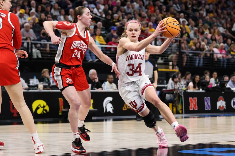 Mar 4, 2023; Minneapolis, MINN, USA; Indiana Hoosiers guard Grace Berger (34) drives to the basket while Ohio State Buckeyes guard Taylor Mikesell (24) defends during the second half at Target Center. Mandatory Credit: Matt Krohn-USA TODAY Sports