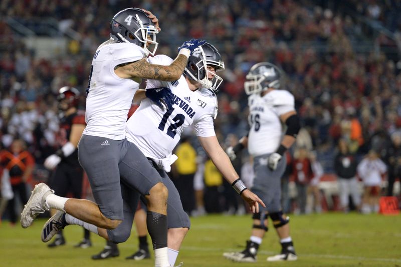 Nov 9, 2019; San Diego, CA, USA; Nevada Wolf Pack quarterback Carson Strong (12) and wide receiver Elijah Cooks (4) celebrate a third quarter touchdown against the San Diego State Aztecs at SDCCU Stadium. Mandatory Credit: Jake Roth-USA TODAY Sports