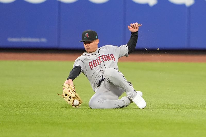 Apr 30, 2025; New York City, New York, USA; Arizona Diamondbacks center fielder Jorge Barrosa (1) attempts to catch New York Mets center fielder Tyrone Taylor (15) (not pictured) line drive during the second inning at Citi Field. Mandatory Credit: Gregory Fisher-Imagn Images
