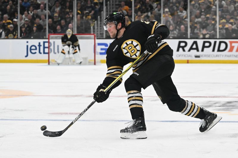 Feb 10, 2024; Boston, Massachusetts, USA; Boston Bruins defenseman Brandon Carlo (25) takes a shot against the Washington Capitals during the third period at the TD Garden. Mandatory Credit: Brian Fluharty-USA TODAY Sports