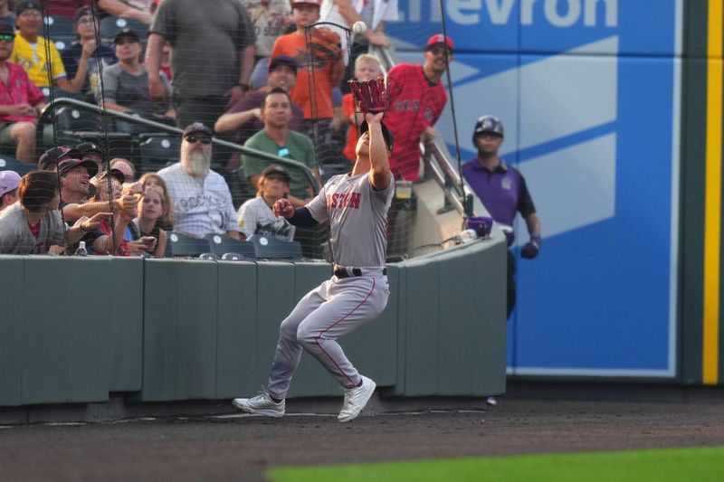 Jul 23, 2024; Denver, Colorado, USA; Boston Red Sox outfielder Rob Refsnyder (30) fields the ball in the first inning against the Colorado Rockies at Coors Field. Mandatory Credit: Ron Chenoy-USA TODAY Sports