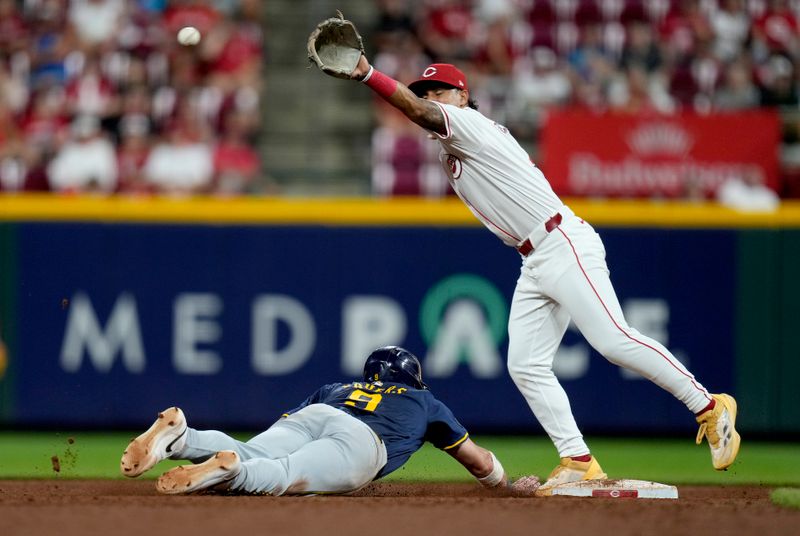 August 31, 2024; Cincinnati, OH; Milwaukee Brewers first base Jake Bauers (9) slides safely back to 2nd base as Cincinnati Reds third base Santiago Espinal (4) waits to make the catch at Great American Ball Park, Saturday, August 31, 2024. The Brewers won 5-4. Mandatory Credit: Cara Owsley -USA TODAY NETWORK