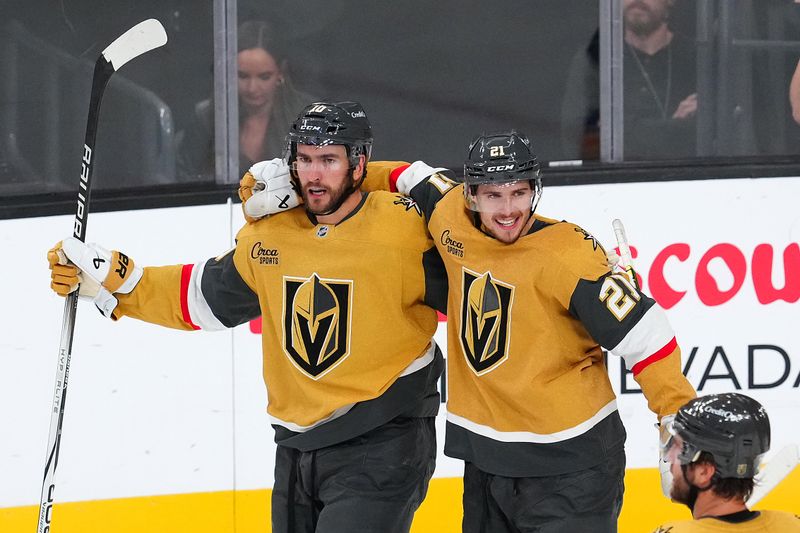 Oct 11, 2024; Las Vegas, Nevada, USA; Vegas Golden Knights center Nicolas Roy (10) celebrates with center Brett Howden (21) after scoring a goal against the St. Louis Blues during the third period at T-Mobile Arena. Mandatory Credit: Stephen R. Sylvanie-Imagn Images