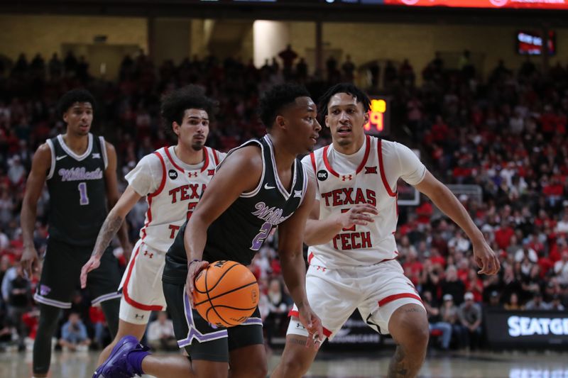 Jan 13, 2024; Lubbock, Texas, USA;  Kansas State Wildcats guard Tylor Perry (2) works the ball against Texas Tech Red Raiders guard Darrion Williams (5) in the second half at United Supermarkets Arena. Mandatory Credit: Michael C. Johnson-USA TODAY Sports