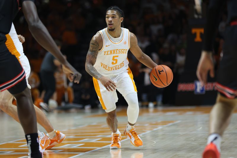 Jan 15, 2025; Knoxville, Tennessee, USA; Tennessee Volunteers guard Zakai Zeigler (5) dribbles against the Georgia Bulldogs during the first half at Thompson-Boling Arena at Food City Center. Mandatory Credit: Randy Sartin-Imagn Images