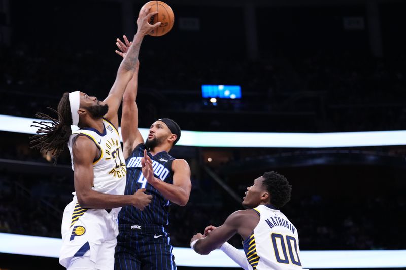 ORLANDO, FLORIDA - OCTOBER 28: Isaiah Jackson #22 of the Indiana Pacers blocks the shot of Jalen Suggs #4 of the Orlando Magic during the first quarter at Kia Center on October 28, 2024 in Orlando, Florida. NOTE TO USER: User expressly acknowledges and agrees that, by downloading and or using this photograph, User is consenting to the terms and conditions of the Getty Images License Agreement. (Photo by Rich Storry/Getty Images)