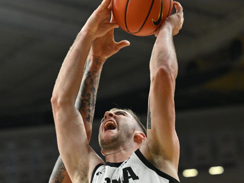 Mar 5, 2023; Iowa City, Iowa, USA; Iowa Hawkeyes guard Connor McCaffery (30) has his shot defended by Nebraska Cornhuskers guard C.J. Wilcher (0) during the second half at Carver-Hawkeye Arena. Mandatory Credit: Jeffrey Becker-USA TODAY Sports