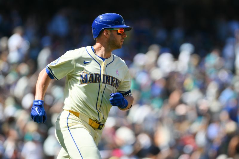 May 12, 2024; Seattle, Washington, USA; Seattle Mariners designated hitter Mitch Garver (18) runs towards first base after hitting a 2-run home run against the Oakland Athletics during the fifth inning at T-Mobile Park. Mandatory Credit: Steven Bisig-USA TODAY Sports