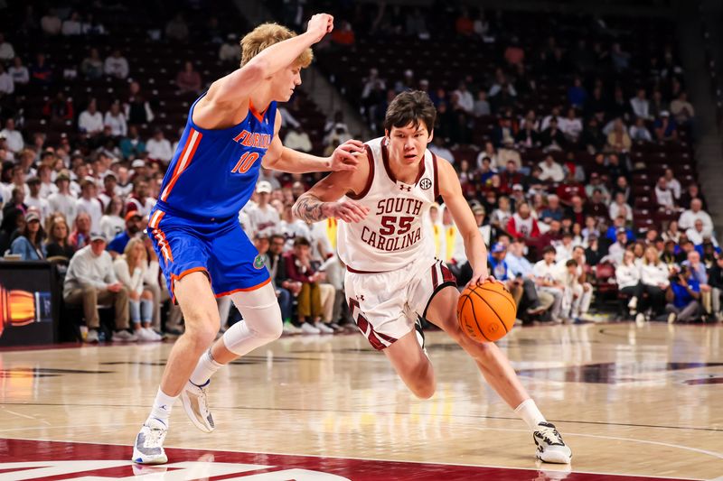 Jan 28, 2026; Columbia, South Carolina, USA; South Carolina Gamecocks guard Mike Sharavjamts (55) attempts to drive around Florida Gators forward Thomas Haugh (10) in the first half at Colonial Life Arena. Mandatory Credit: Jeff Blake-Imagn Images