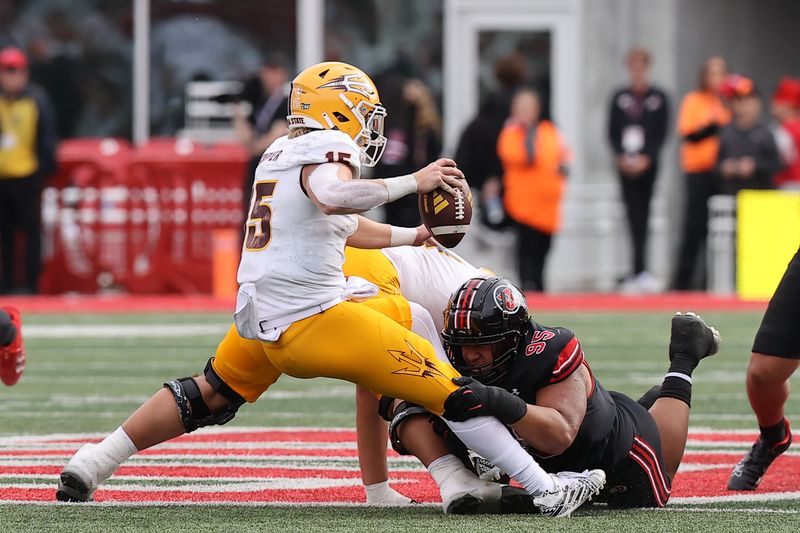 Nov 4, 2023; Salt Lake City, Utah, USA; Arizona State Sun Devils quarterback Jacob Conover (15) is sacked by Utah Utes defensive tackle Aliki Vimahi (95) in the fourth quarter at Rice-Eccles Stadium. Mandatory Credit: Rob Gray-USA TODAY Sports