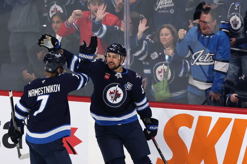 Oct 18, 2025; Winnipeg, Manitoba, CAN; Winnipeg Jets right wing Nino Niederreiter (62) celebrates a goal against the Nashville Predators with Winnipeg Jets center Vladislav Namestnikov (7) in the first period at Canada Life Centre. Mandatory Credit: James Carey Lauder-Imagn Images