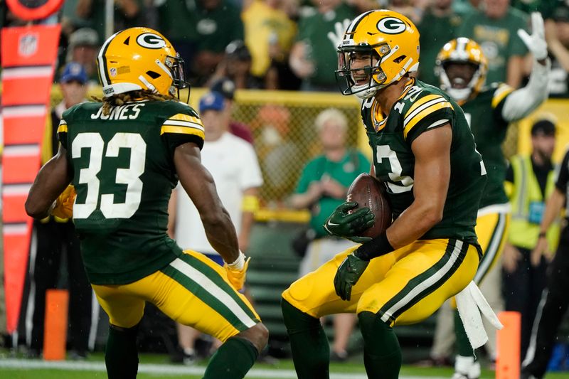 Green Bay Packers wide receiver Allen Lazard (13) celebrates with teammate running back Aaron Jones (33) after catching a 5-yard touchdown pass during the first half of an NFL football game against the Chicago Bears Sunday, Sept. 18, 2022, in Green Bay, Wis. (AP Photo/Morry Gash)