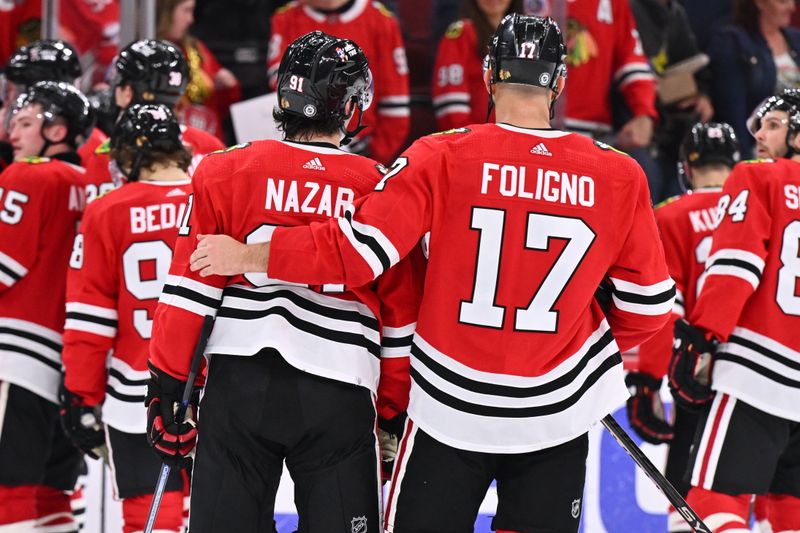 Apr 14, 2024; Chicago, Illinois, USA; Chicago Blackhawks forward Nick Foligno (17) puts his arm around forward Frank Nazar (91) after their game against the Carolina Hurricanes at United Center. Mandatory Credit: Jamie Sabau-USA TODAY Sports